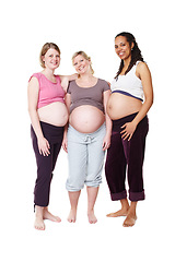 Image showing Pregnant, happy and diversity women pregnancy portrait, mother to be with wellness success smile with white background in studio. Support, maternity and friends with pilates, health or yoga clothes