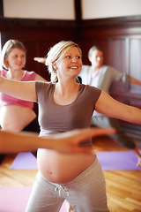 Image showing Fitness, pregnant and wellness women in studio doing cardio exercise in pregnancy community for women. Happy mother to be with abdomen doing pilates or stretching with motivation smile in yoga class