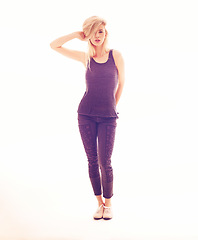 Image showing Fashion, model and beauty with a young woman posing in studio against a white background with creative lighting. Portrait of a sexy female looking sensual, elegant and confident in purple clothes