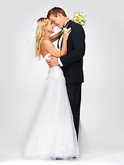 Image showing Wedding smile, couple hug and white background studio portrait. Happy and in love man and beautiful young woman, marriage flowers bouquet in bride hand and lean to kiss husbands cheerful face.