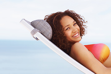 Image showing Freedom, happy and smile of a black woman relax and lounge at a beach with a bikini in summer. Portrait of a young woman natural beauty with happiness, positive and travel vacation mindset outdoor