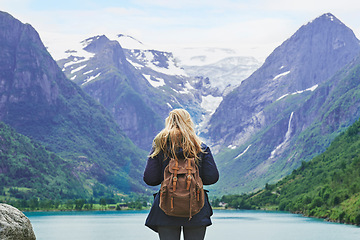 Image showing Adventure backpacking woman enjoying view of majestic mountain lake explore travel discover beautiful earth