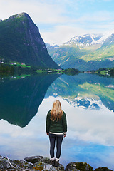 Image showing Adventure woman enjoying view of majestic mountain lake explore travel discover beautiful earth