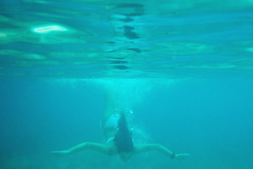 Image showing Beautiful woman swimming underwater on paradise beach freedom wellbeing lifestyle summer vacation wanderlust