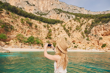 Image showing Beautiful woman on speed boat driving to paradise beach island taking photo smart phone discover summer adventure vacation