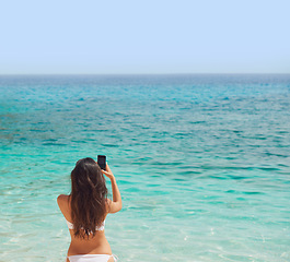 Image showing Beautiful woman taking photos with smart phone technology on paradise beach destination summer wanderlust vacation