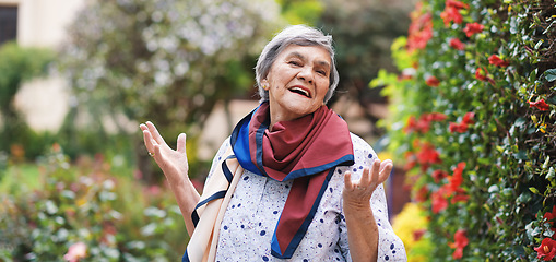 Image showing Portrait happy old woman smiling enjoying retirement wearing colorful scarf in beautiful garden