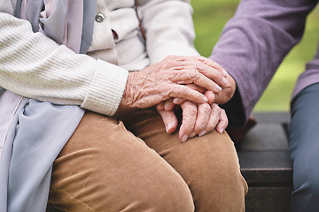 Image showing Two elderly women sitting on bench in park holding hands happy life long friends enjoying retirement