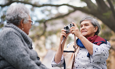 Image showing Happy old woman taking photo of friend using camera in park
