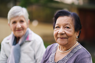 Image showing Two elderly women sitting on bench in park smiling happy life long friends enjoying retirement