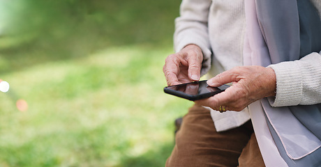Image showing Old woman hands using smartphone texting sending messages on mobile phone outdoors