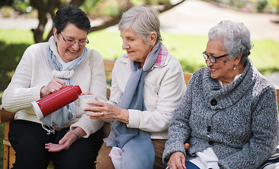 Image showing Happy old women sitting on bench in park drinkign tea enjoying retirement together