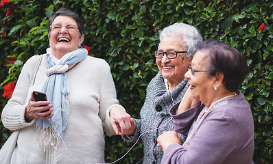 Image showing Funny elderly women listening to music on smartphone wearing earphones smiling enjoying fun celebrating retirement together outdoors