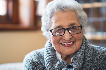 Image showing Portrait beautiful elderly woman smiling sitting on sofa at home enjoying retirement