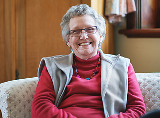 Image showing Happy elderly woman smiling sitting on sofa at home enjoying retirement