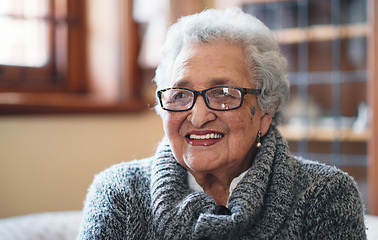 Image showing Portrait beautiful elderly woman smiling sitting on sofa at home enjoying retirement