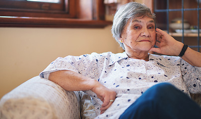 Image showing Portrait happy elderly woman smiling sitting on sofa at home enjoying retirement