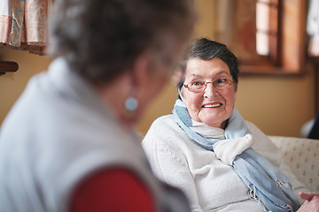 Image showing Happy elderly woman talking to friend sitting on sofa in retirement home having conversation