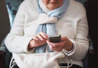 Image showing Happy elderly woman using smartphone texting browsing on mobile phone sending messages sitting on couch at home