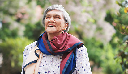 Image showing Portrait happy old woman smiling enjoying retirement wearing colorful scarf in beautiful garden