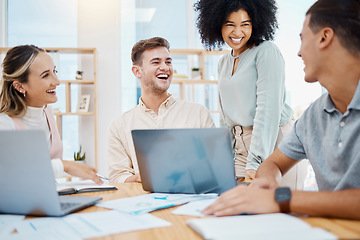 Image showing Success, teamwork and happy business group working on laptop and doing paperwork in office together. Laughing colleagues checking report or documents while planning, chatting, joking and having fun