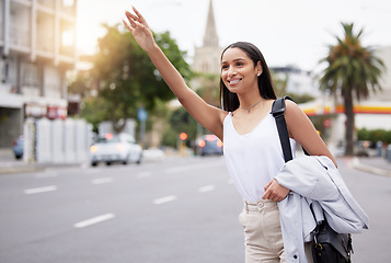 Image showing Happy woman showing hand sign for a taxi while standing in a street in the city, business travel for a meeting or event. smiling female on her daily commute, gesture hail cab while on a trip downtown