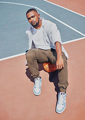 Image showing Fashion, basketball court and model influencer or man posing on a court in an urban city with fashionable style. Male portrait of trendy, stylish and cool person in sports promotion for ball game