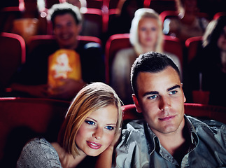 Image showing Love couple at cinema or movie theatre to watch entertainment film together at movie theater on a romantic date. Young happy people smile, romance and relationship at movies cinematography theater