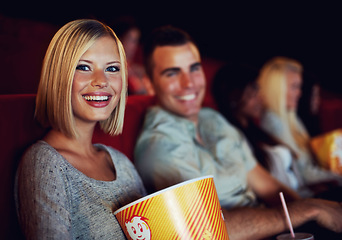 Image showing Movie, popcorn and smile with woman on a date with man at cinema interior or theater event. Happy, film or show screen with couple eating snacks and watching together at night time