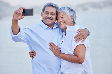 Image showing Senior couple taking selfie on phone with smile for social media app online with 5g network while on a date together. Love, marriage retirement man and woman on beach sand mock up white background