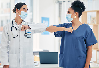 Image showing Woman doctor and nurse, in a hospital elbow greeting, in surgical mask during the covid pandemic. Teamwork, healthcare worker and medical professional with protection from virus during consultation