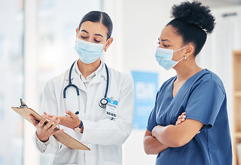 Image showing Doctor, nurse and covid checklist for safety policy with face mask in medical facility, hospital or clinic. Healthcare, communication and results on sick, illness or vaccine medicine research