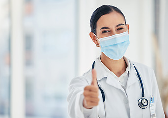 Image showing Thumbs up, mask portrait and doctor in agreement with healthcare procedure at hospital. Woman medical worker with yes hand gesture for satisfaction with safety protocol at care facility.