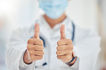 Image showing Thumbs up doctor hand sign for covid surgery success, support and yes in a hospital. Medical and healthcare worker showing thank you, agreement or goal completion hands gesture in a health clinic