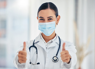 Image showing Covid, portrait and thumbs up doctor with mask happy with hospital hygiene for infection safety. Healthcare woman with hand gesture of success for virus prevention in consultation room.