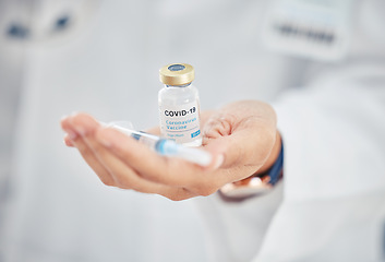 Image showing Covid vaccine vial, doctor hands and medicine injection for healthcare cure, wellness safety and antiviral booster shot in hospital clinic. Closeup of corona virus medical treatment immunity support