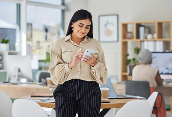 Image showing Entrepreneur on phone with social media online in a modern office. Business woman smile while chatting and checking email at work or sharing good news of a successful startup with a mobile smartphone