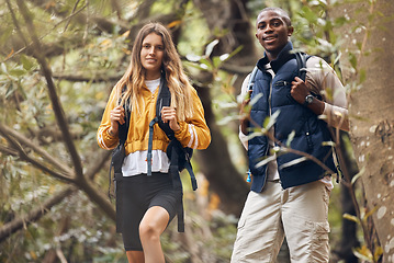 Image showing Portrait of interracial couple hiking in a nature forest environment or woods together in spring. Man and woman walking in sustainable outdoor ecology during trekking adventure or travel on holiday