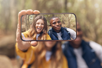 Image showing Happy couple taking a selfie on a phone while in nature on a romantic date in the forest. Multiracial, love and traveling man and woman taking picture with smartphone camera after hiking in the woods