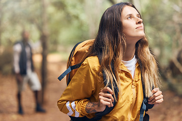 Image showing Wellness, nature and adventure with a female backpacker explore a forest, breathing fresh air and looking around. Young woman enjoying the view of the woods while out hiking and having fun