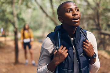 Image showing Hiking young black man in forest nature with wow face traveling with backpack in woods. Surprise, happy and active African person or backpacker in trees trekking on jungle freedom adventure in summer