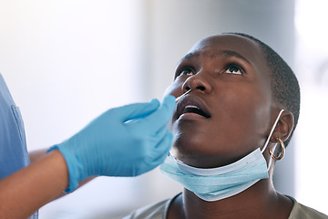 Image showing Covid, test and medicine with a doctor or nurse and a patient doing a rapid antigen or pcr test in the hospital. Healthcare, wellness and insurance with a woman in consultation for a nasal swab