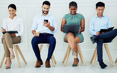 Image showing Recruitment, interview and diversity group of people in a company, job or corporate waiting room office. Relax men and women using a laptop, notebook and phone or other tech at a design hiring agency