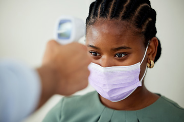 Image showing Covid, mask or doctor with an infrared thermometer to take temperature and consulting a woman patient with a fever in an appointment. Healthcare, medicine and wellness with a female at the hospital