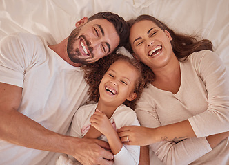 Image showing Happy family, girl and laughing parents having fun and spending quality time together at home from above. Portrait of funny mother, father lying with their child and sharing love in their bedroom