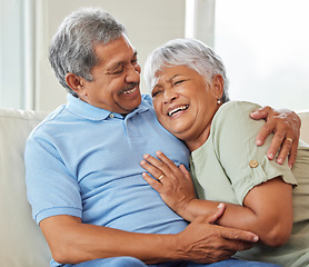 Image showing Love, care and happy senior couple hugging each other while bonding and relaxing on sofa at home. Elderly man and woman sitting on a couch in the living room while embracing, talking and laughing.