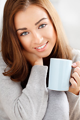 Image showing Portrait, woman drinking tea or coffee against a studio background and a smile. Beauty, happiness and happy girl model with perfect white teeth and a mug, drink or beverage in hand relaxing.