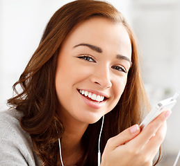 Image showing Woman streaming music with smartphone technology, audio content on headphones and browse internet on weekend. Happy girl listening to podcast at home, healthy skin natural beauty and portrait closeup