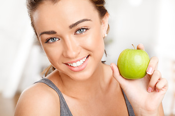 Image showing Woman eating apple for healthy, fresh and balanced diet with nutrition, fruit and vitamins. Portrait face of fitness, young and happy vegan for weightloss food, organic wellness and beauty skincare