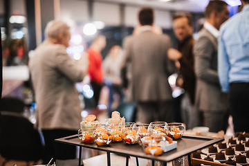 Image showing Blurred image of businesspeople at banquet business meeting event. Business and entrepreneurship events concept. Focused on the canapes.